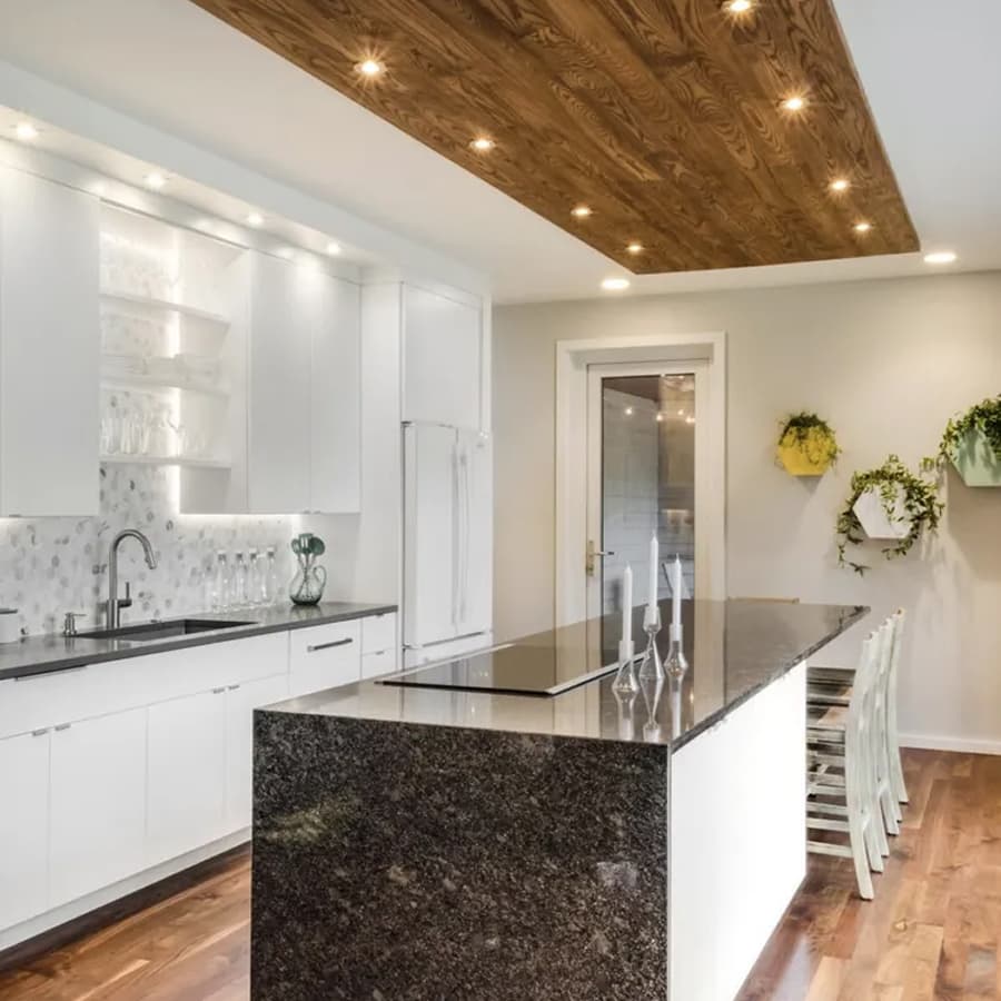 Custom kitchen renovation featuring white cabinets and marble countertops